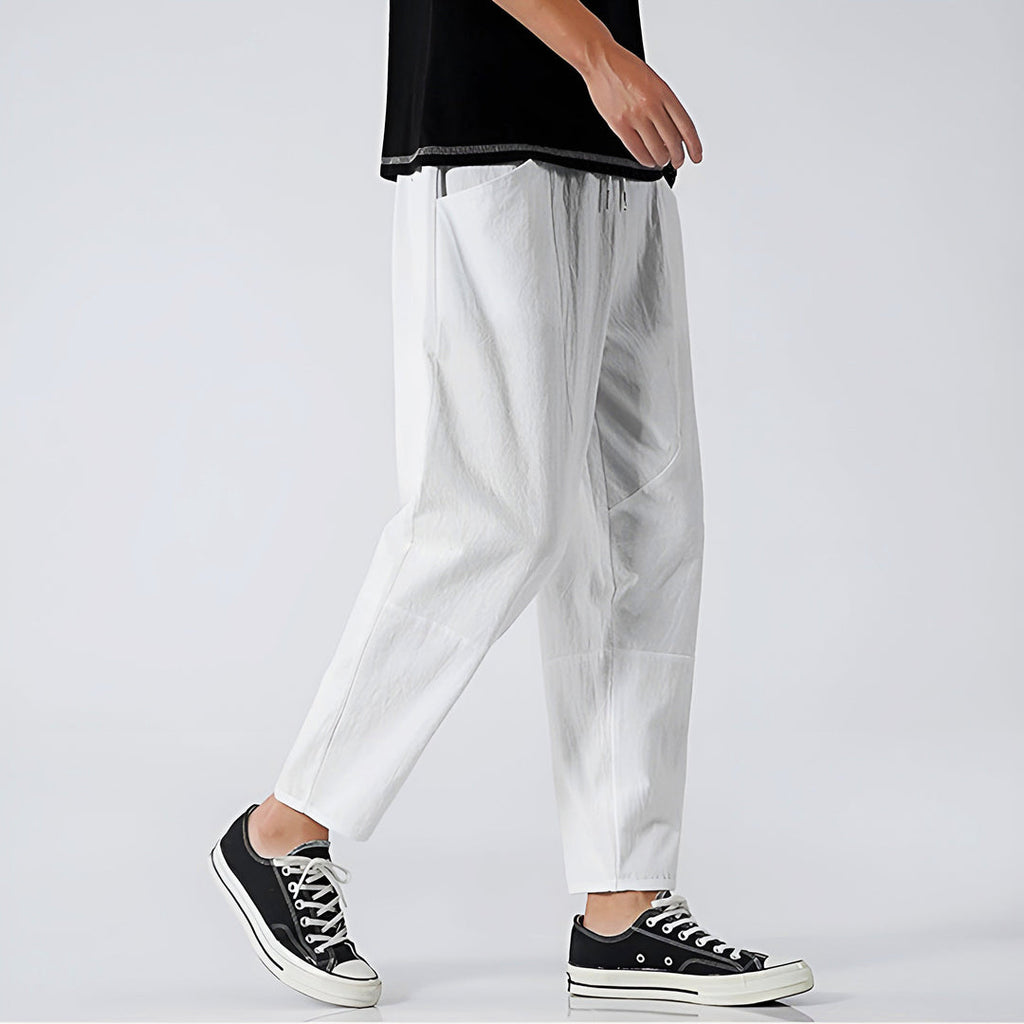 Men's white cropped trousers with black trainers