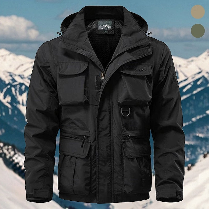 Man wearing the black hooded explorer jacket in the mountains