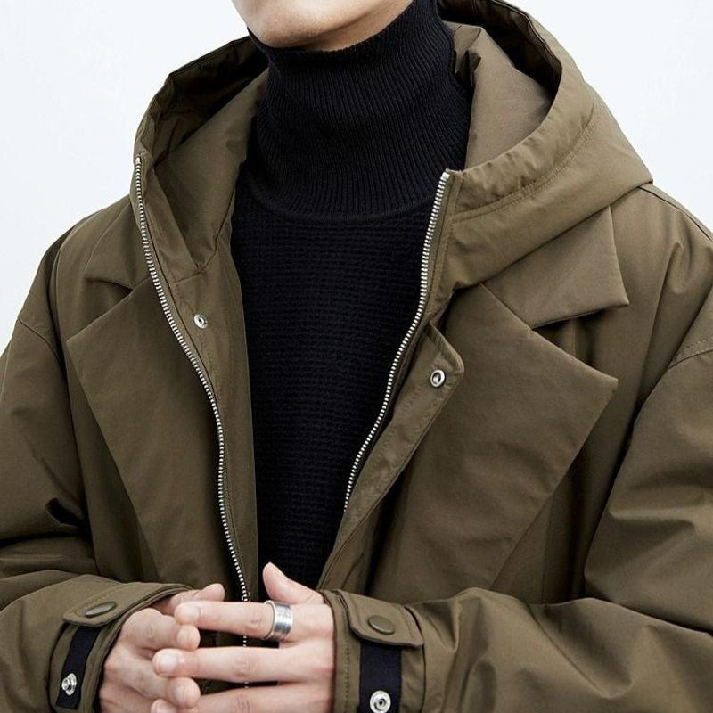 Man wearing the army green parka with hood up