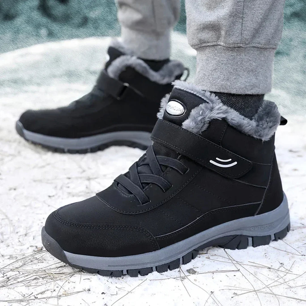 Men's black winter ankle boots worn outdoors