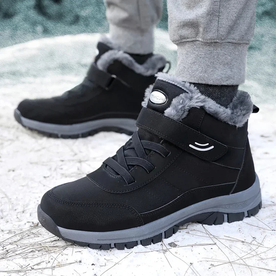 Men's black winter ankle boots worn outdoors