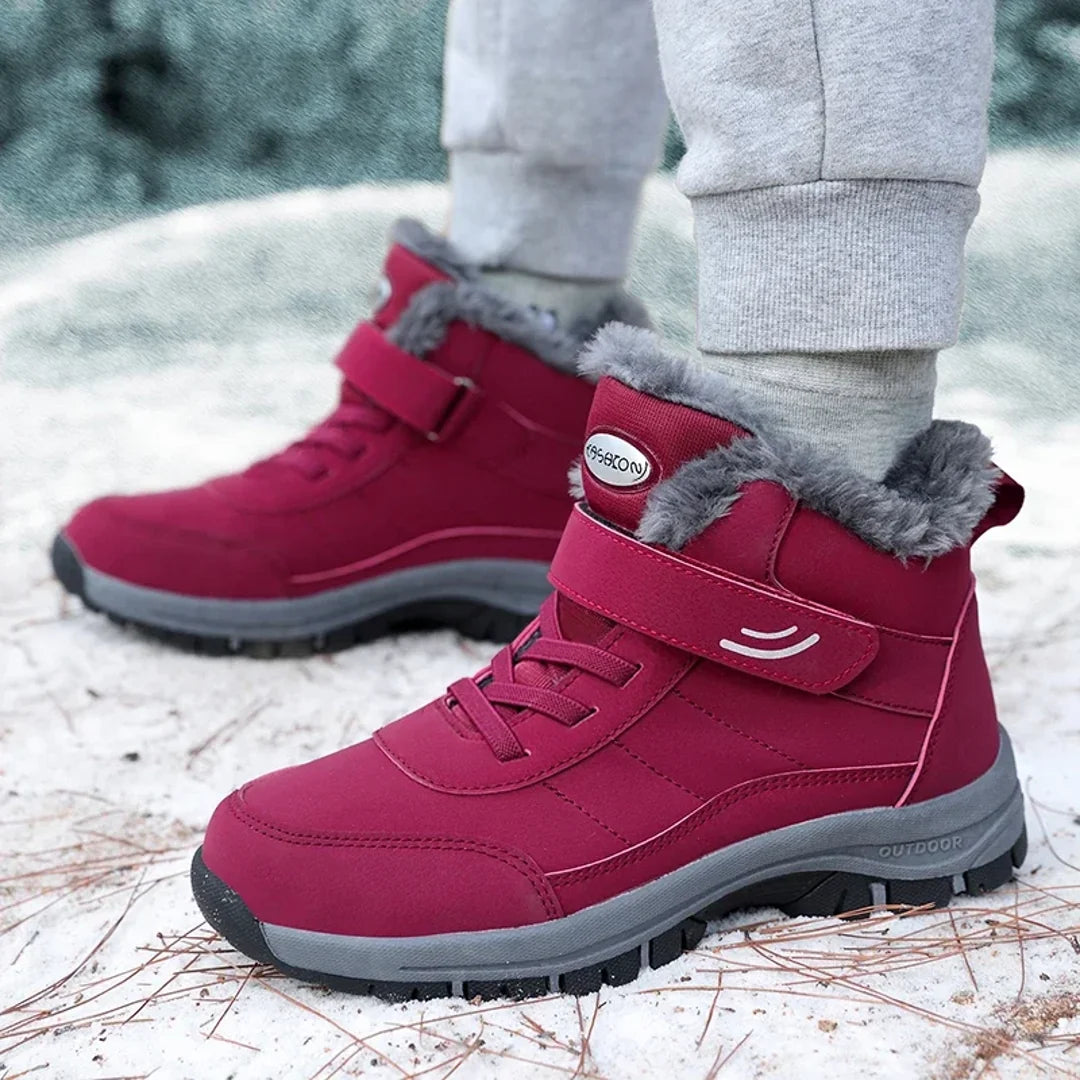 Men's red winter boots worn in the snow
