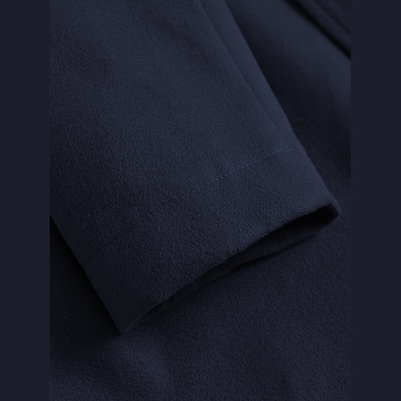 Close-up of the sleeve cuff on the navy overcoat