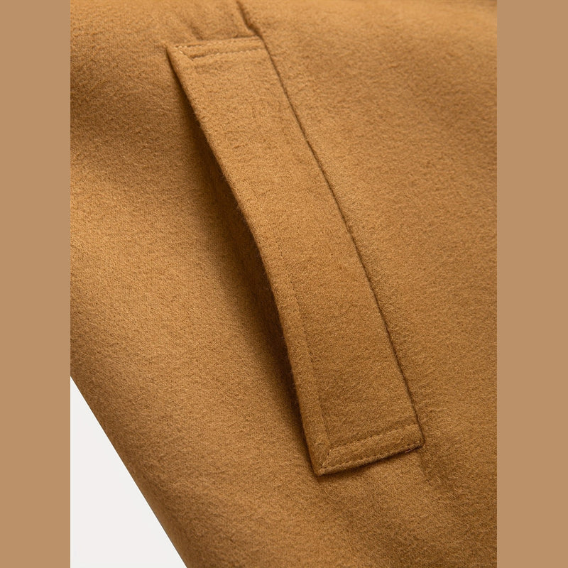 Close-up of the flap pocket on the brown overcoat