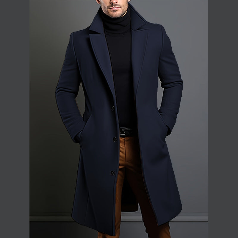 Man wearing the navy blue long overcoat