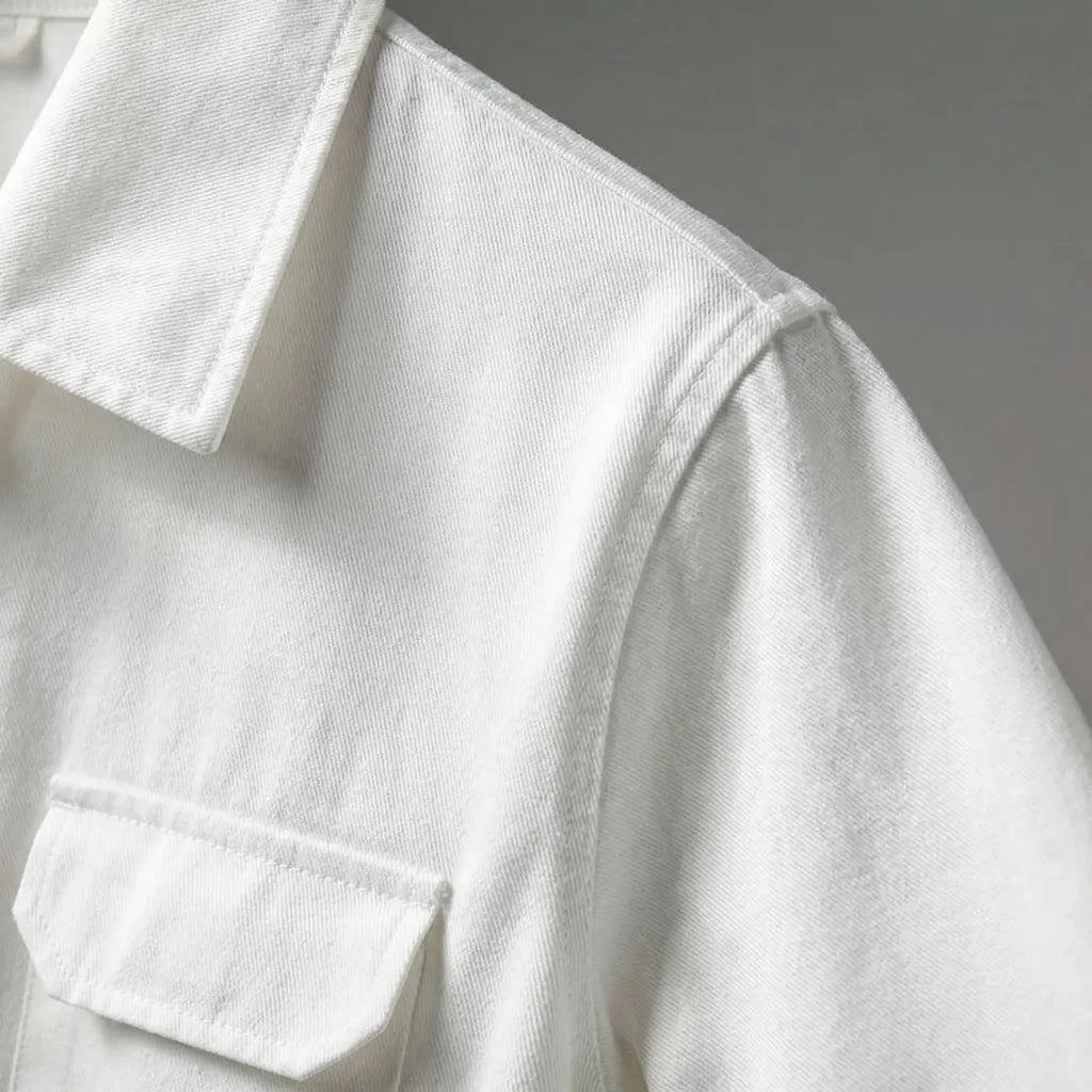 Close-up of the collar and chest flap pocket on the white jumpsuit