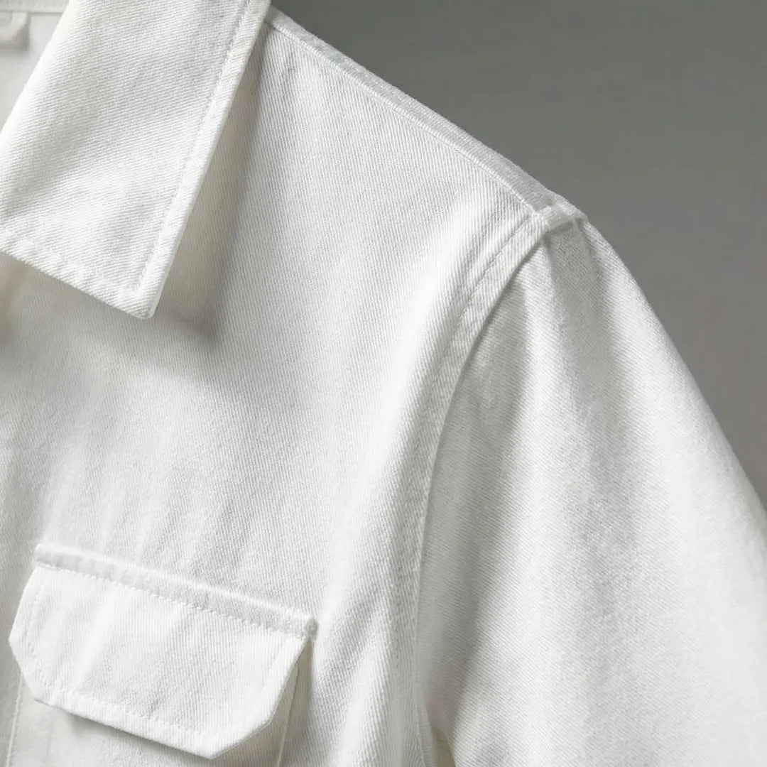 Close-up of the collar and chest flap pocket on the white jumpsuit
