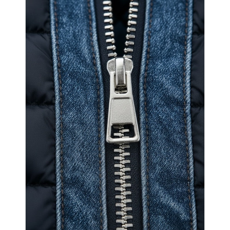 Men's quilted hybrid jacket with denim-look panels in blue, close-up of front zip