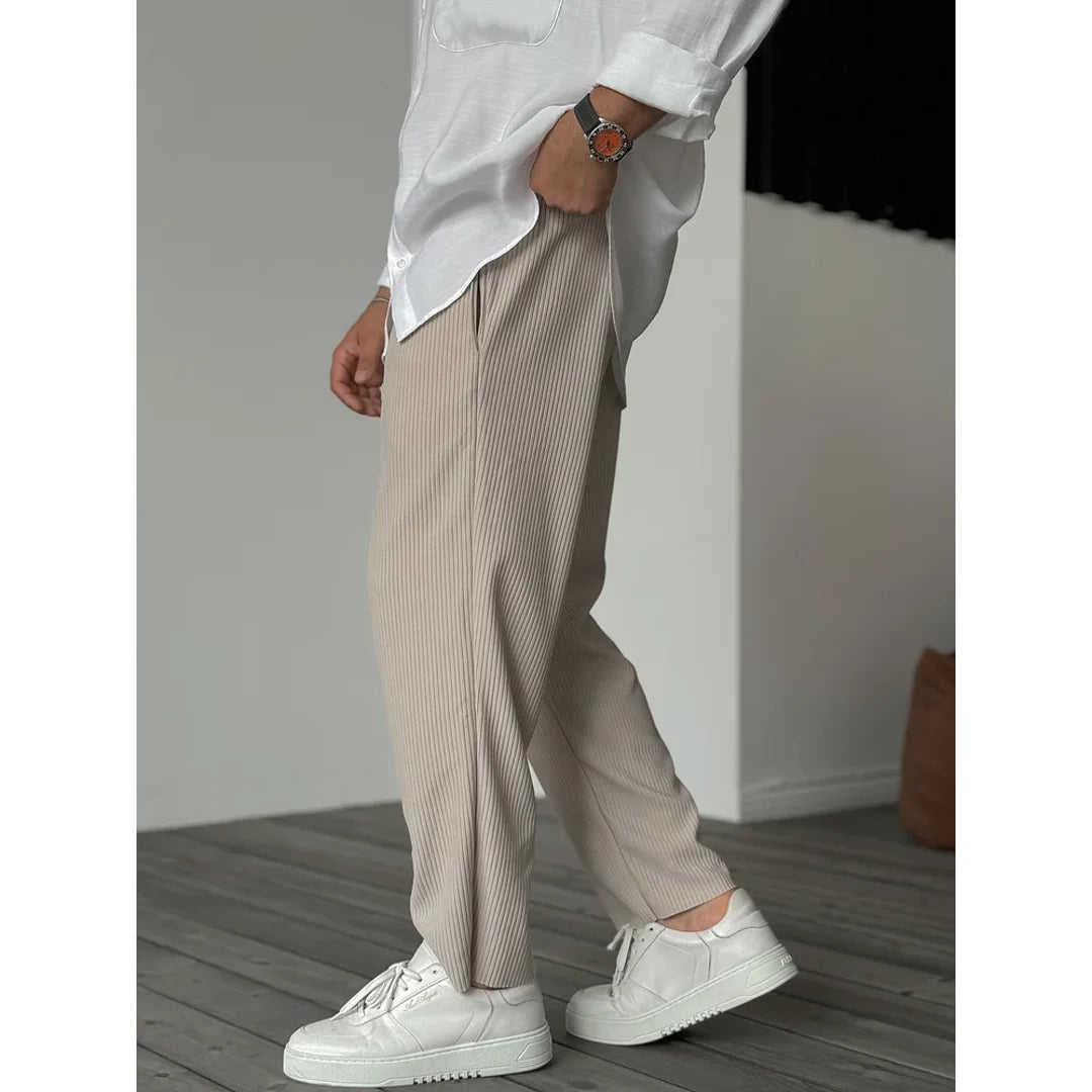 Men's beige trousers styled with a white shirt