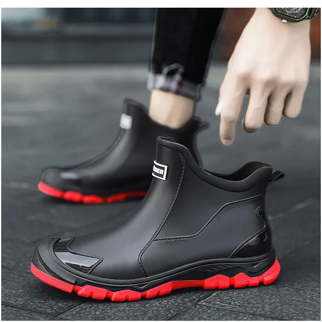 Man putting on black rain ankle boots