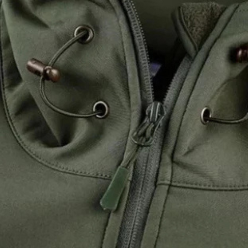 Close-up of the drawcord and zip on the green jacket