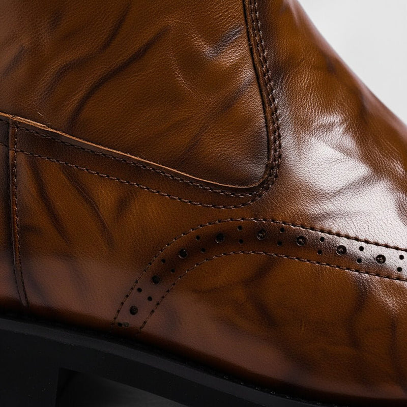 Close-up of brown brogue perforation detail