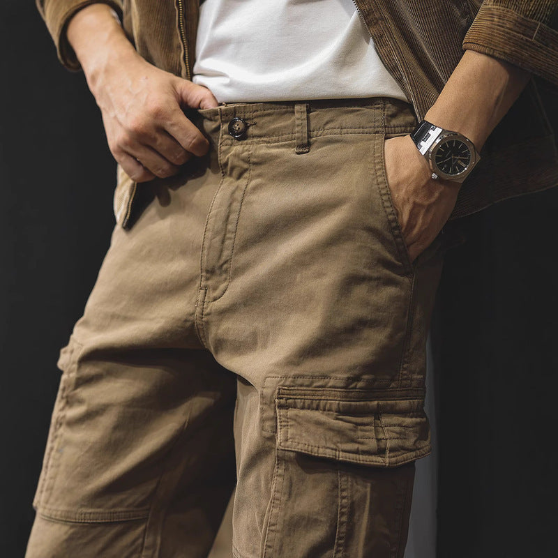 Close-up of brown cargo trousers with side flap pocket