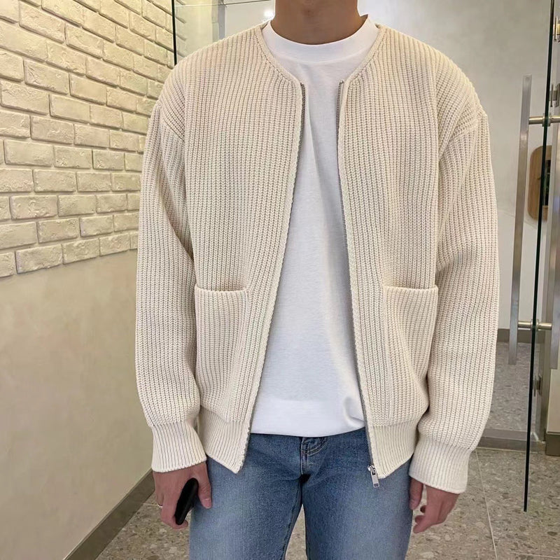 Man wearing cream ribbed zip-up cardigan with pockets