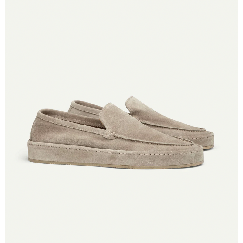 Pair of beige men's slip-on loafers – side view