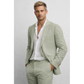 Man in green two-piece suit with tailored blazer