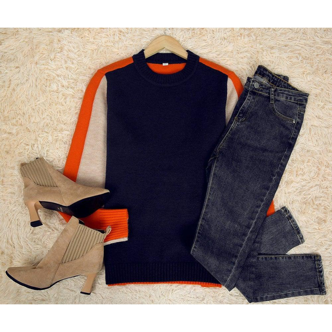 Women's colour block sweater styled with jeans and boots