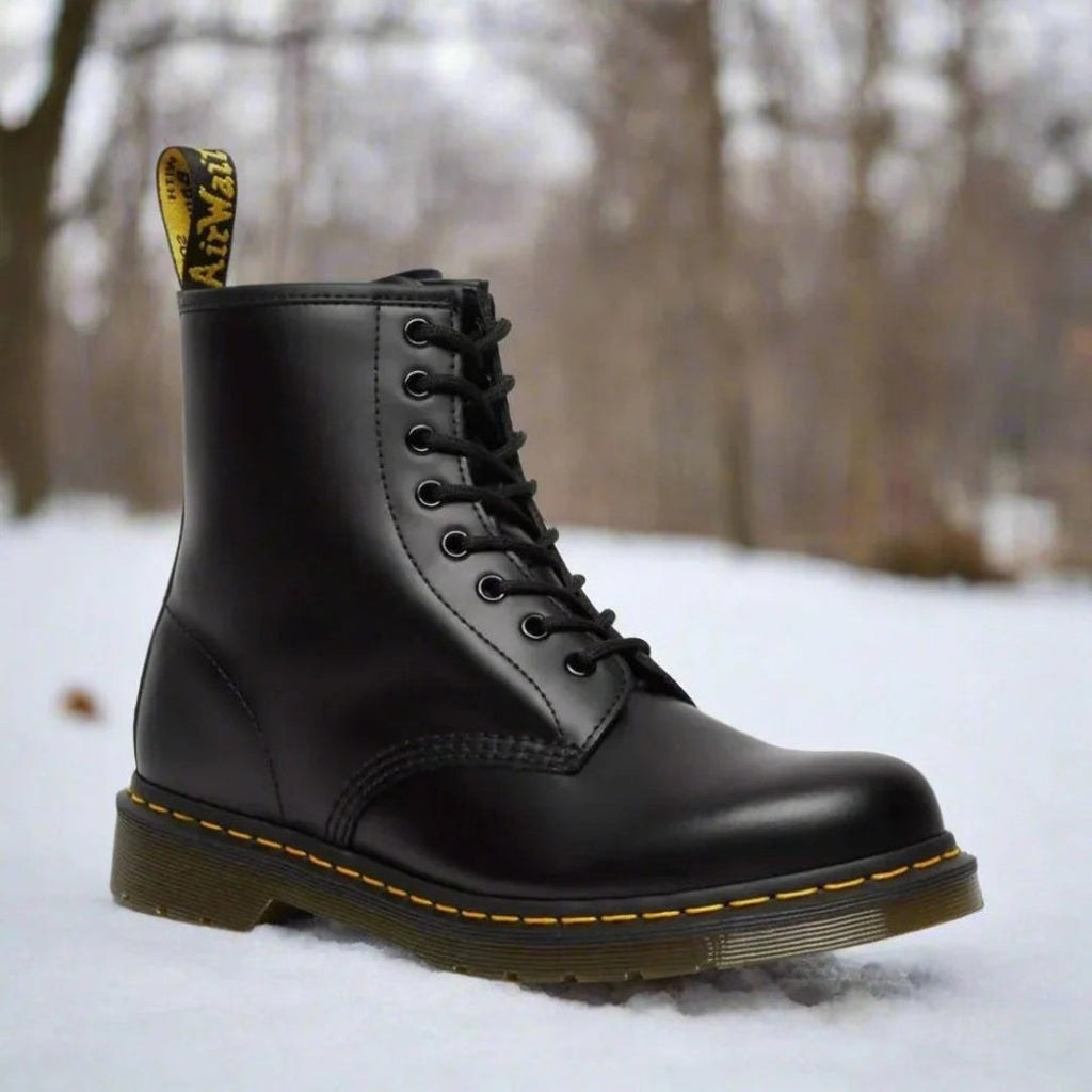 Women's black eight-eyelet lace-up boot in the snow