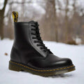 Women's black eight-eyelet lace-up boot in the snow
