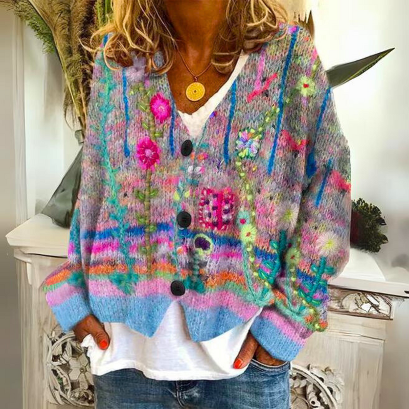 Women's floral knit cardigan with V-neck button front worn over a white top