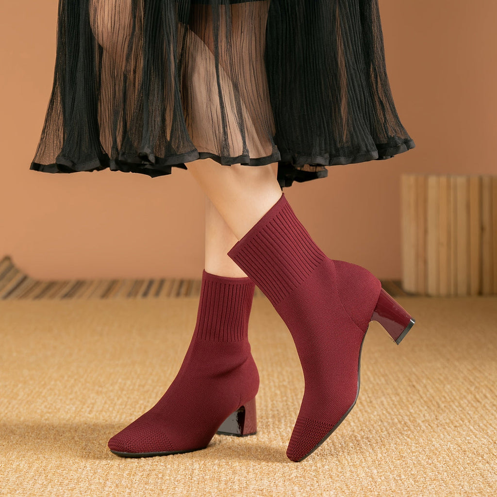 Woman wearing burgundy knit sock boots