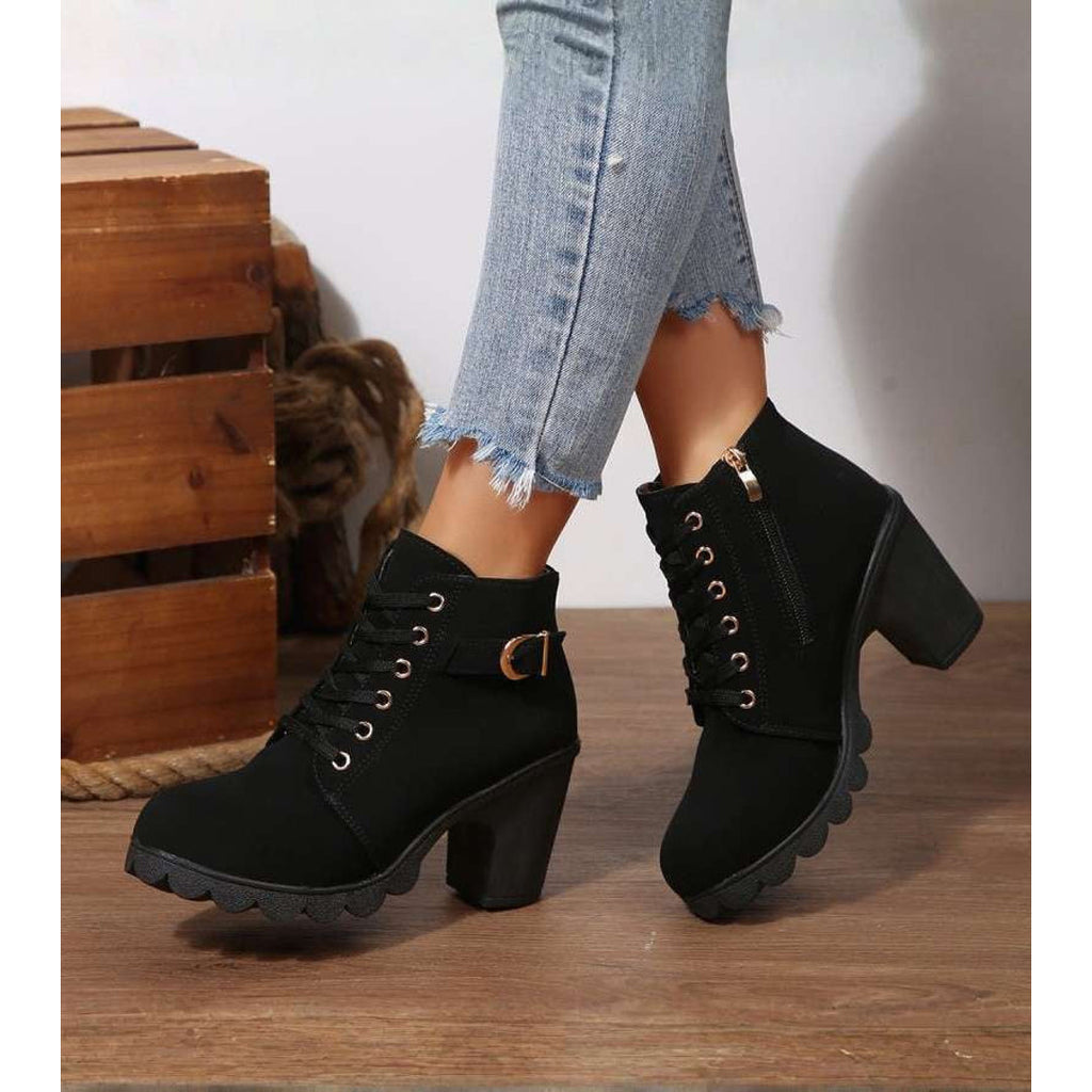 Woman wearing black block heel ankle boots with jeans