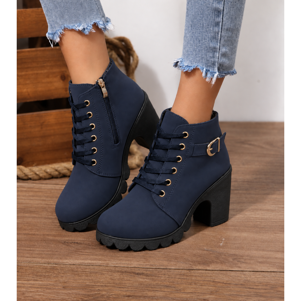 Woman wearing navy block heel ankle boots