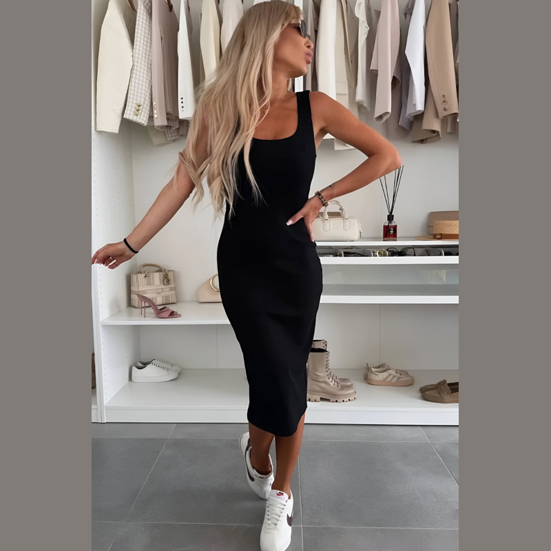 Woman wearing the black dress and cardigan set – side view