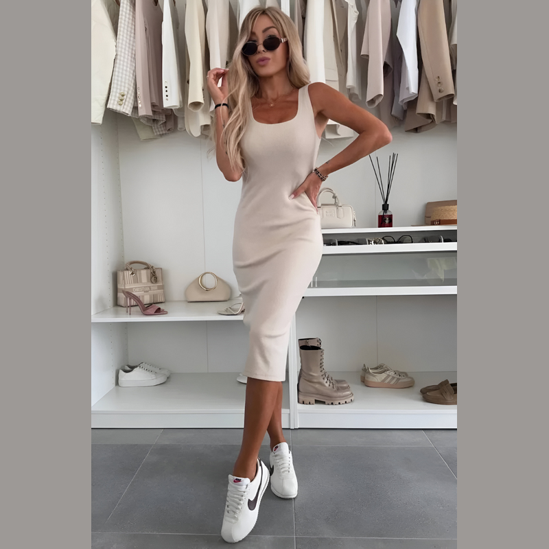 Woman wearing the beige dress and cardigan set – side view