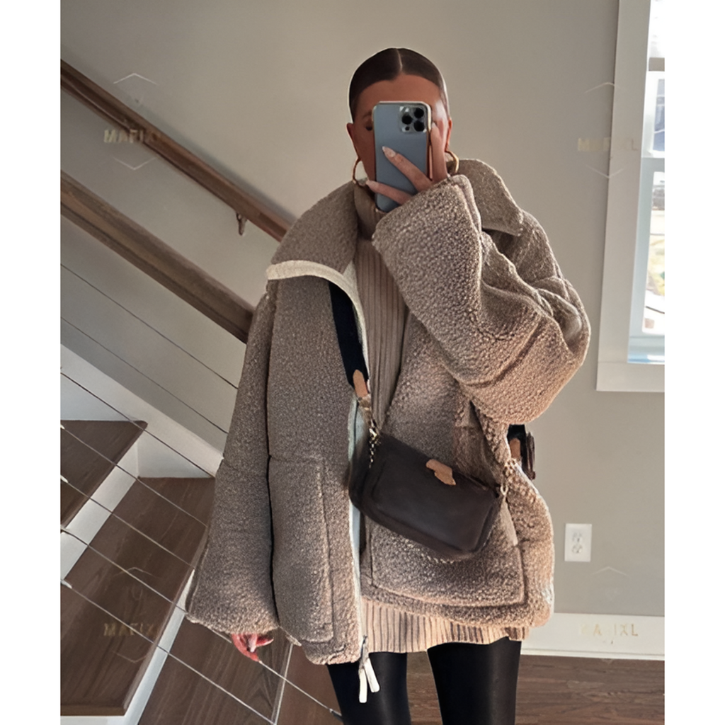 Woman wearing a taupe teddy jacket on the stairs