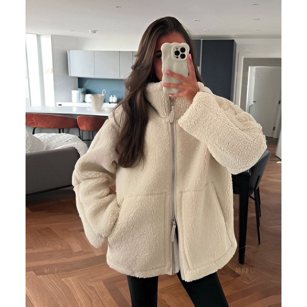 Woman wearing a cream teddy zip jacket