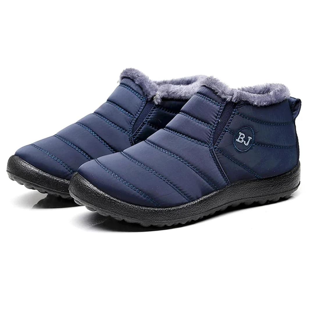 Pair of women's navy quilted boots – studio view