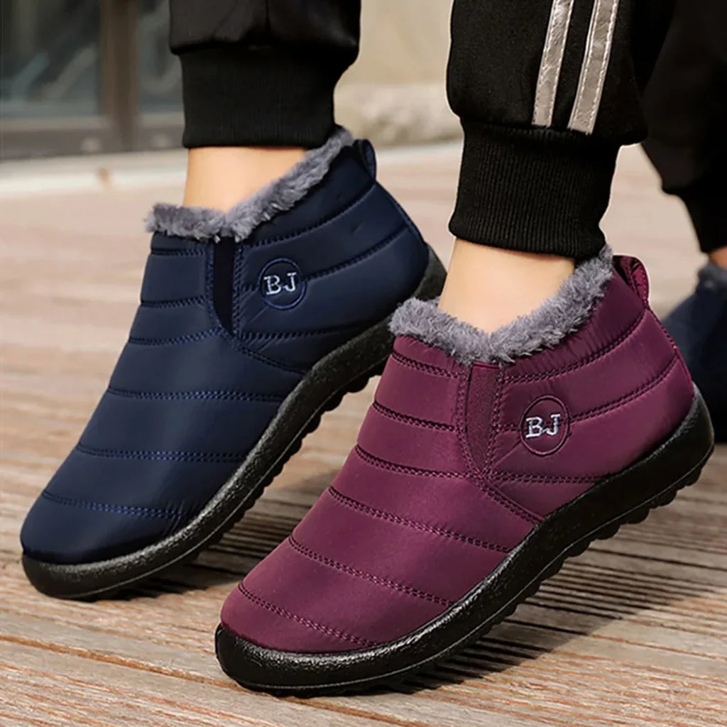 Woman wearing navy and burgundy quilted boots