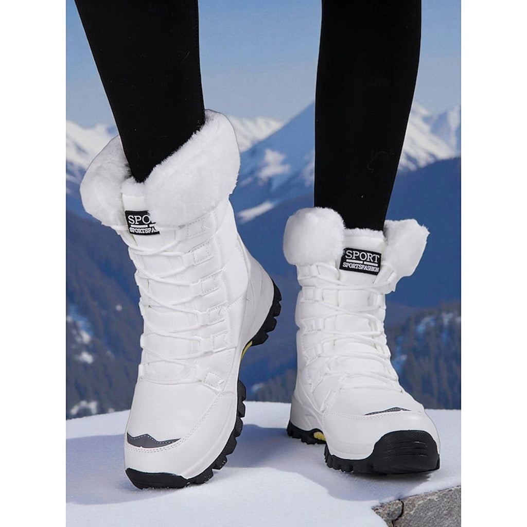 Women's white quilted lace-up snow boots in the mountains