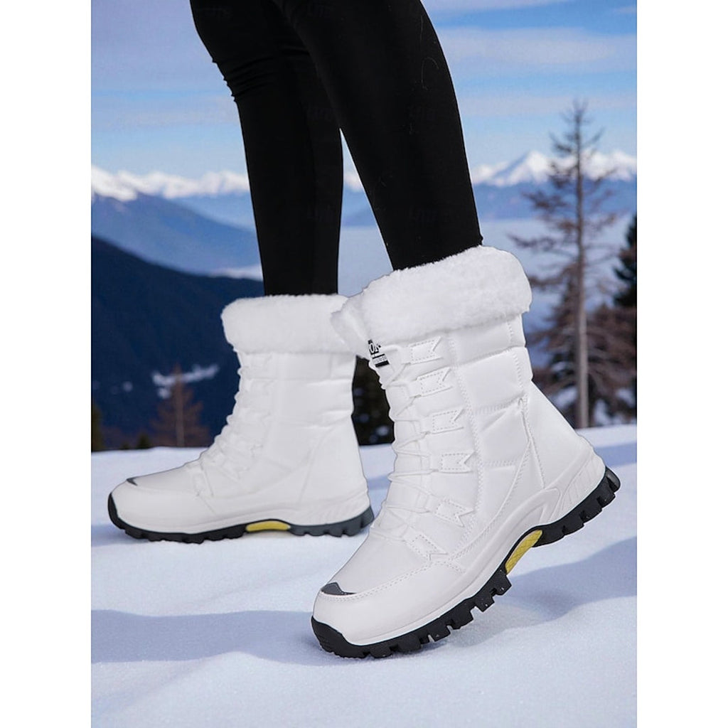 Women's white snow boots worn in the snow