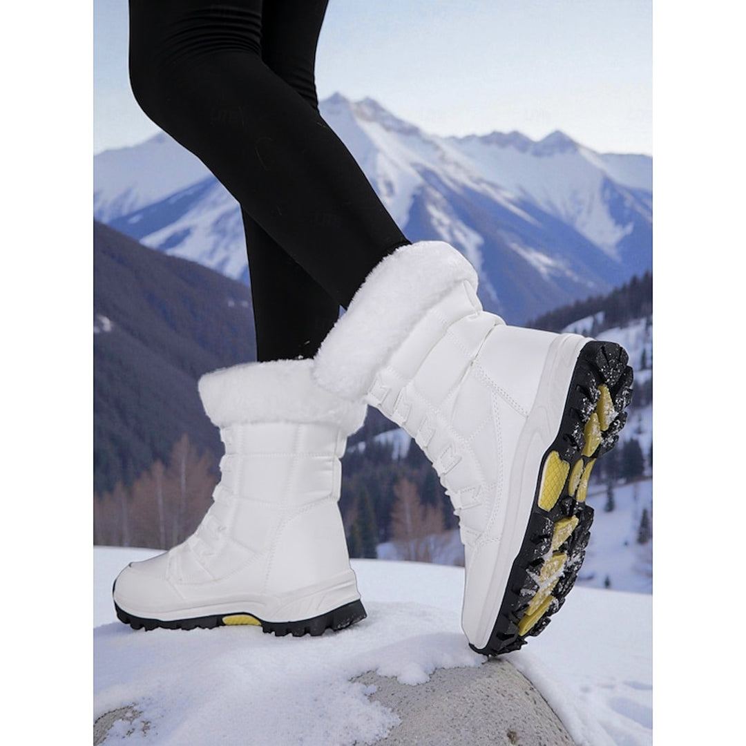 Women's white snow boot showing the tread sole
