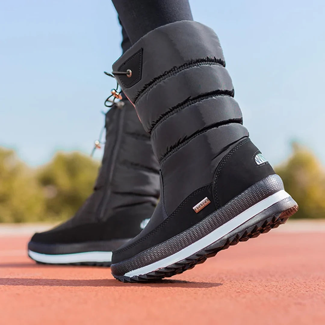 Woman walking in black quilted snow boots