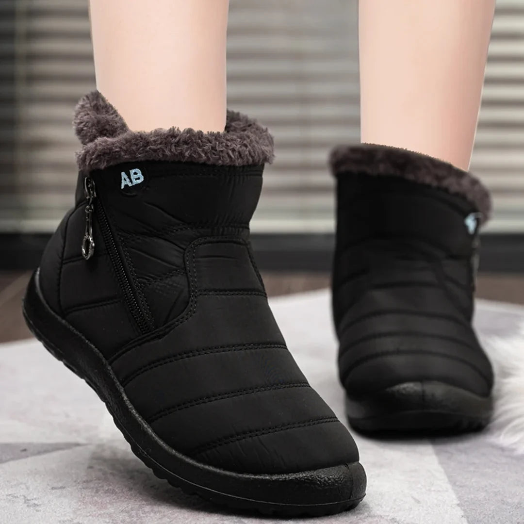 Woman wearing black quilted winter ankle boots
