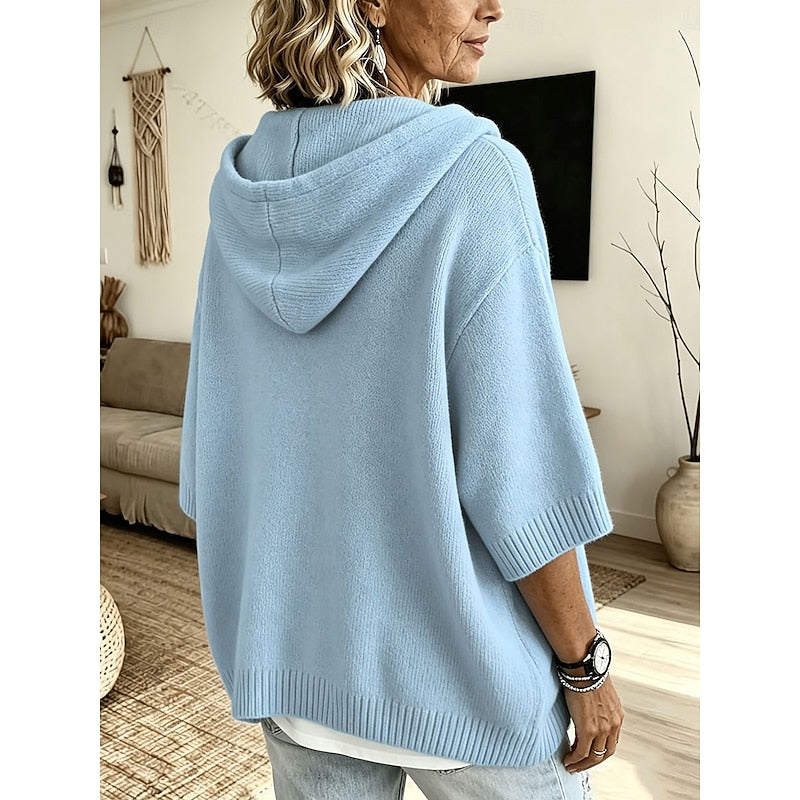 Woman wearing the sky blue hooded sweater with the hood up
