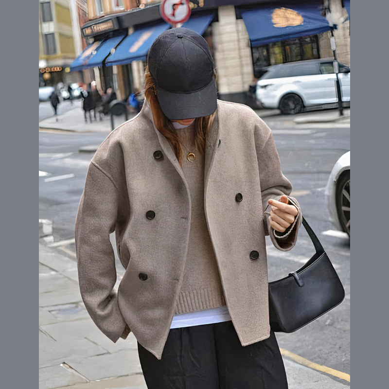 Woman wearing the light brown short coat in the city