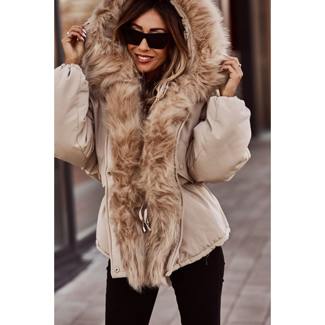 Woman in a beige fluffy hood parka with sunglasses