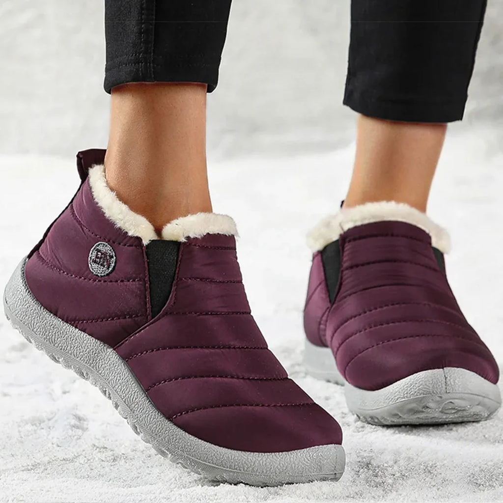 Woman wearing burgundy quilted ankle boots