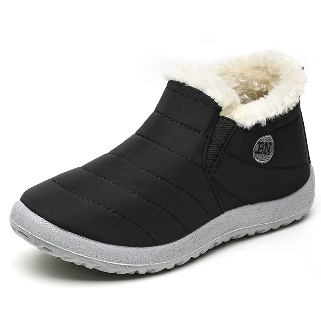 Women's black quilted ankle boot with cream collar – side view