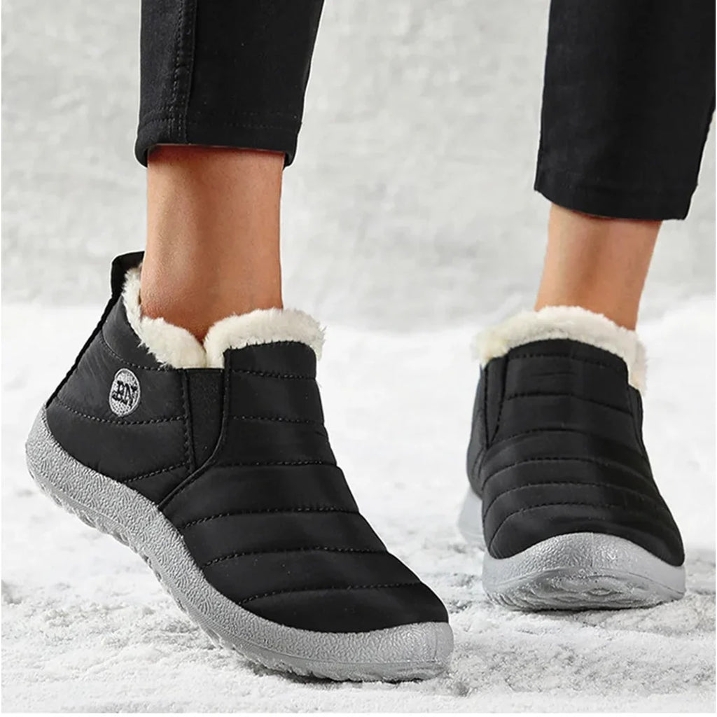 Woman walking in black quilted ankle boots