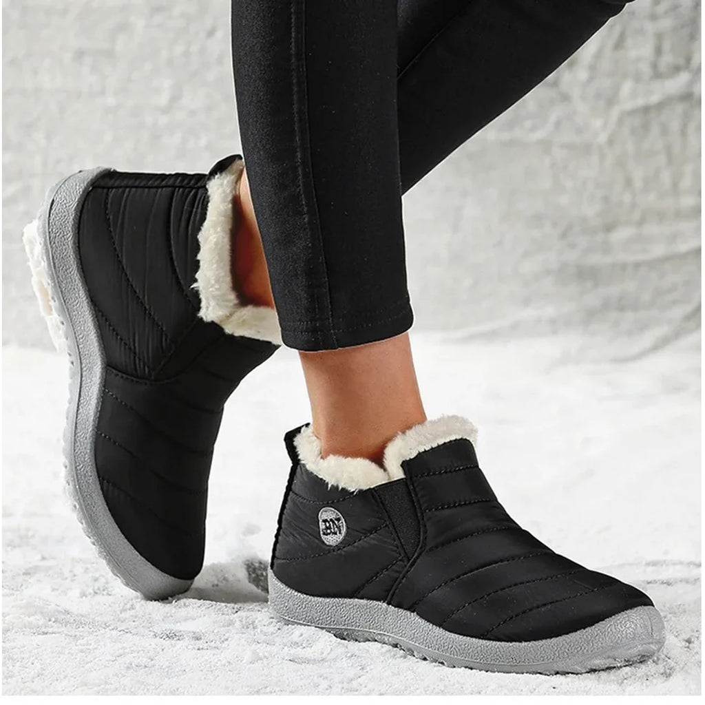 Woman wearing black quilted ankle boots – side view
