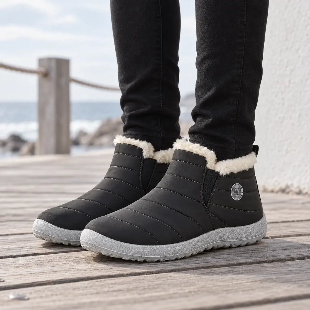 Woman wearing black quilted ankle boots outdoors