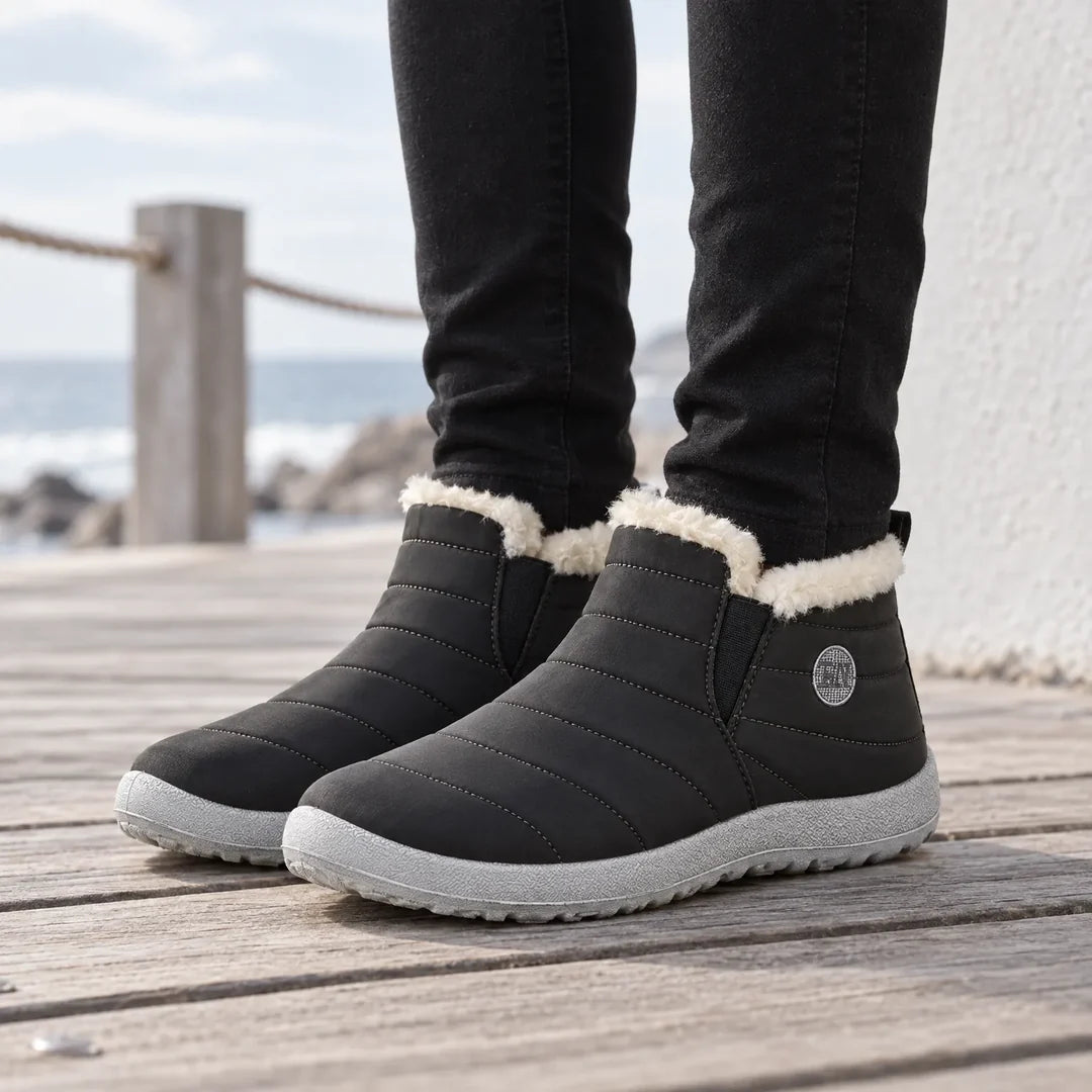 Woman wearing black quilted ankle boots outdoors