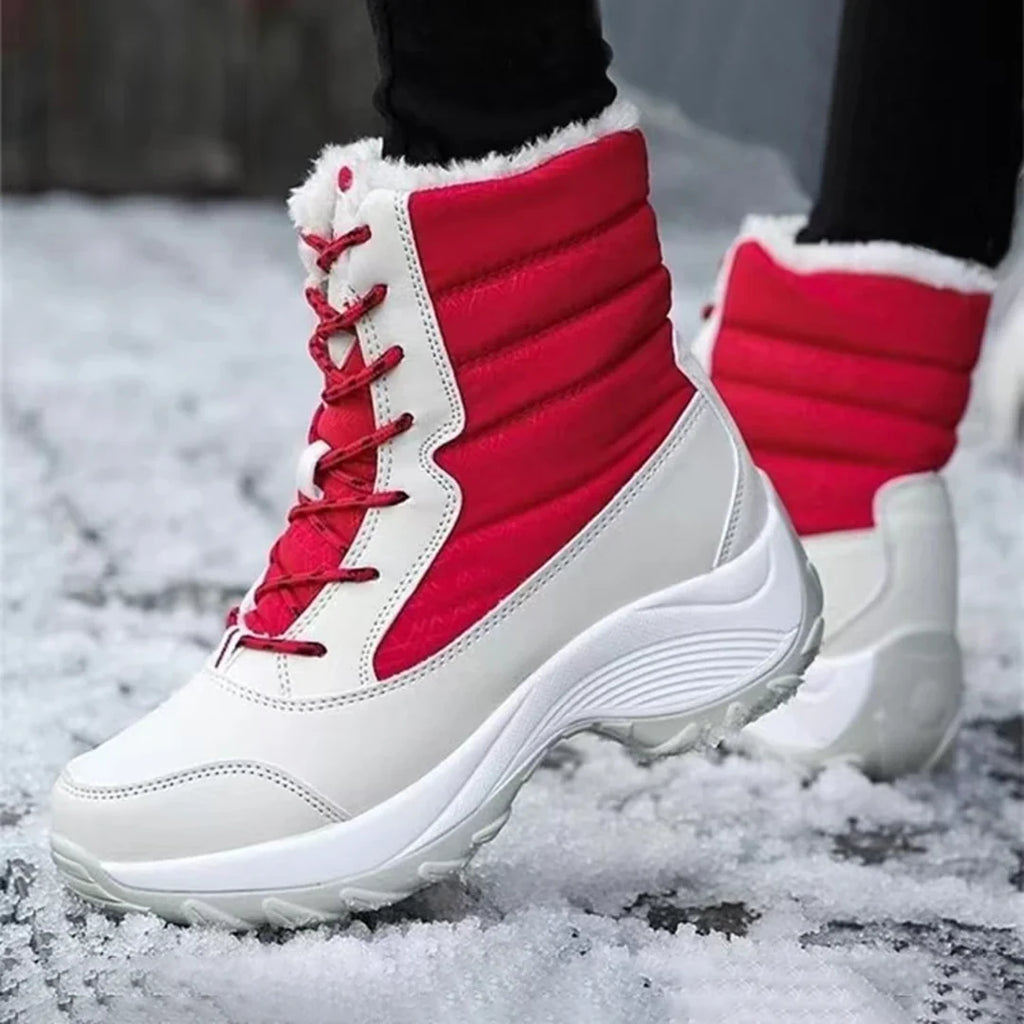 Woman wearing red and cream snow boots in the snow