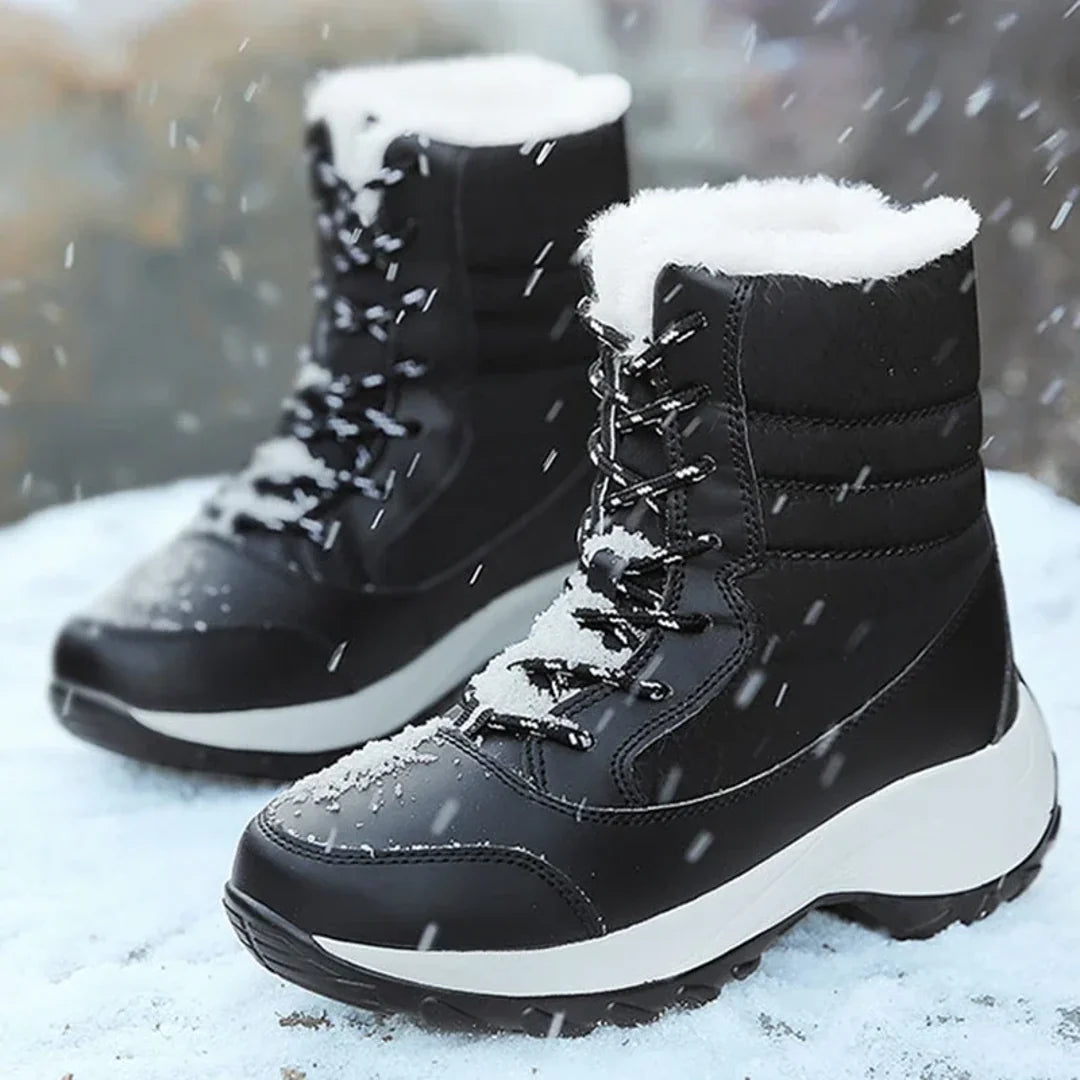Women's black snow boots worn in the snow
