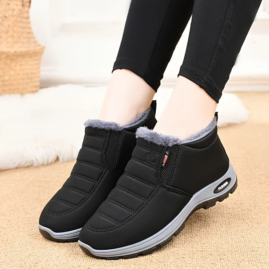 Woman wearing black winter ankle boots